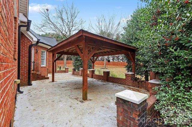 a view of a house with a sink and wooden fence