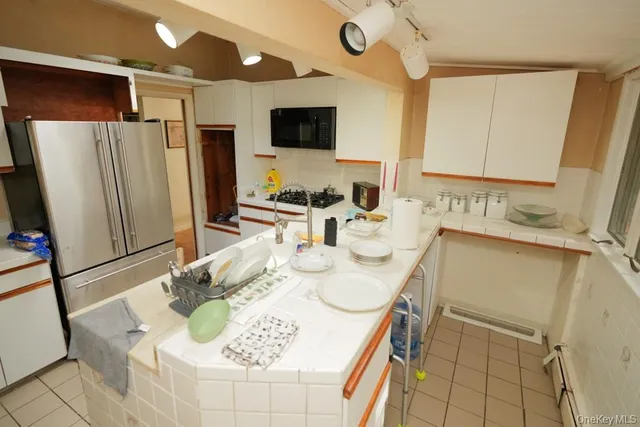 a kitchen with stainless steel appliances kitchen island granite countertop a sink and a stove