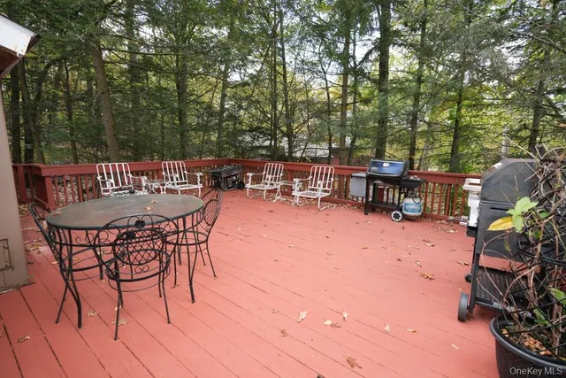 a view of a roof deck with wooden fence and floor