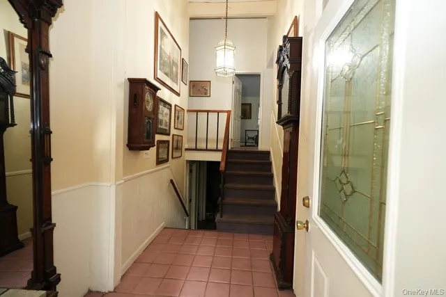 a living room with a couch and a dresser next to a window