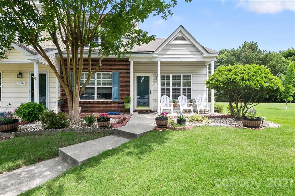 a view of a house with backyard sitting area and garden