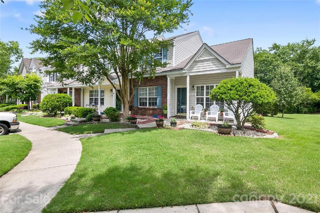 10930 Kinston Ridge Place, Unit 1237 Charlotte, NC 28273 - Photo 2 of 32 a view of a house with backyard sitting area and garden