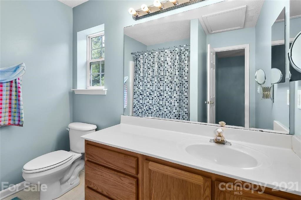 10930 Kinston Ridge Place, Unit 1237 Charlotte, NC 28273 - Photo 15 of 32 a bathroom with a sink a toilet and shower