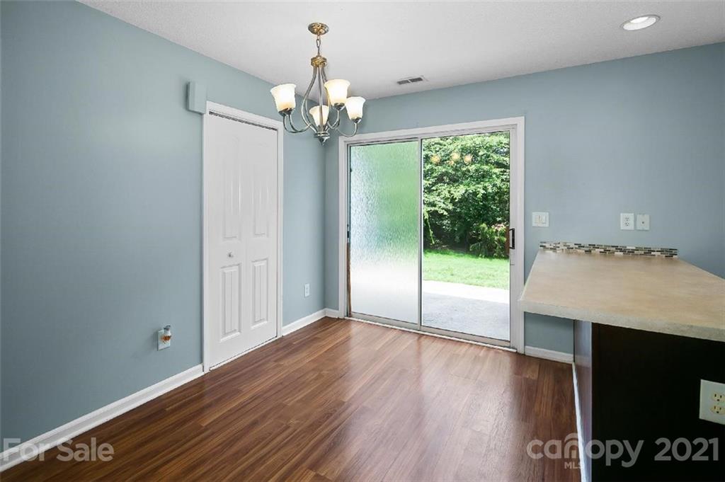 10930 Kinston Ridge Place, Unit 1237 Charlotte, NC 28273 - Photo 21 of 32 a view of an empty room with wooden floor and a window