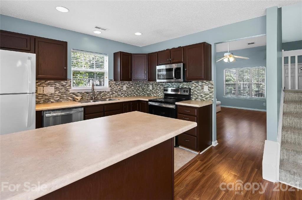 10930 Kinston Ridge Place, Unit 1237 Charlotte, NC 28273 - Photo 22 of 32 a kitchen with stainless steel appliances a sink stove and refrigerator