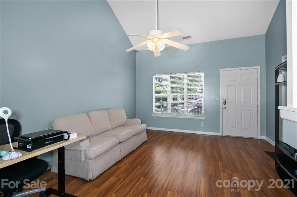 10930 Kinston Ridge Place, Unit 1237 Charlotte, NC 28273 - Photo 26 of 32 a living room with furniture and a wooden floor