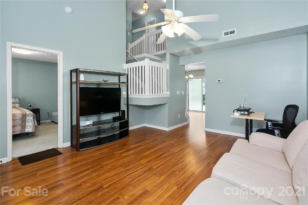 10930 Kinston Ridge Place, Unit 1237 Charlotte, NC 28273 - Photo 28 of 32 a living room with furniture and a flat screen tv
