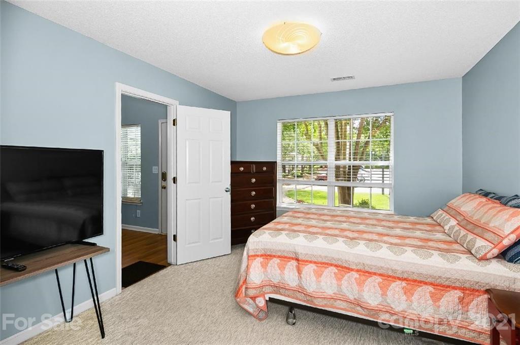 10930 Kinston Ridge Place, Unit 1237 Charlotte, NC 28273 - Photo 29 of 32 a bedroom with a bed and a flat screen tv