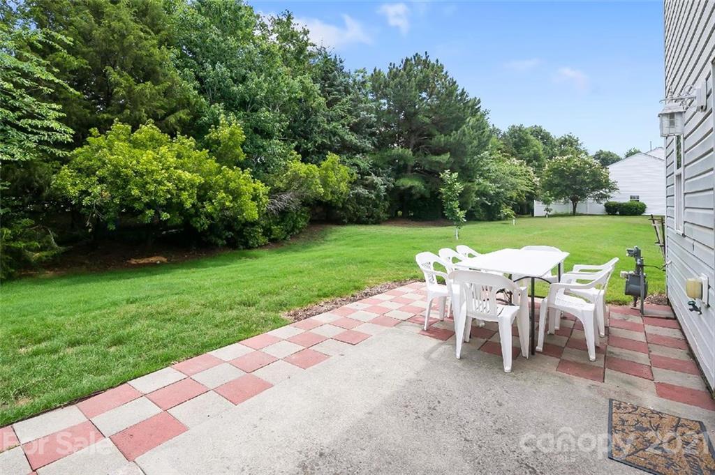 10930 Kinston Ridge Place, Unit 1237 Charlotte, NC 28273 - Photo 8 of 32 a view of a table and chairs in backyard