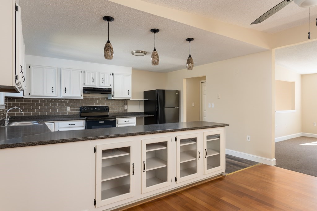 12 Gibbs Road Middleboro, MA 02346 - Photo 22 of 38 a kitchen with stainless steel appliances a stove a sink and white cabinets