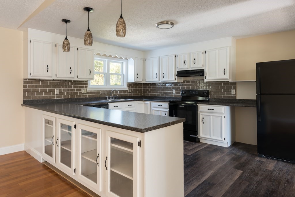 12 Gibbs Road Middleboro, MA 02346 - Photo 23 of 38 a kitchen with stainless steel appliances granite countertop a sink and a refrigerator
