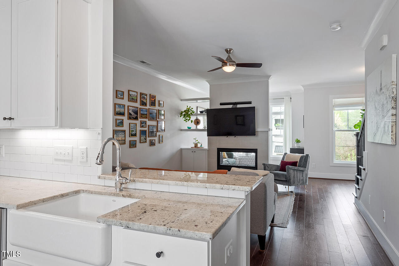 638 Watauga Street Raleigh, NC 27604 - Photo 11 of 41 a living room with stainless steel appliances granite countertop a sink dishwasher and a fireplace with wooden floor