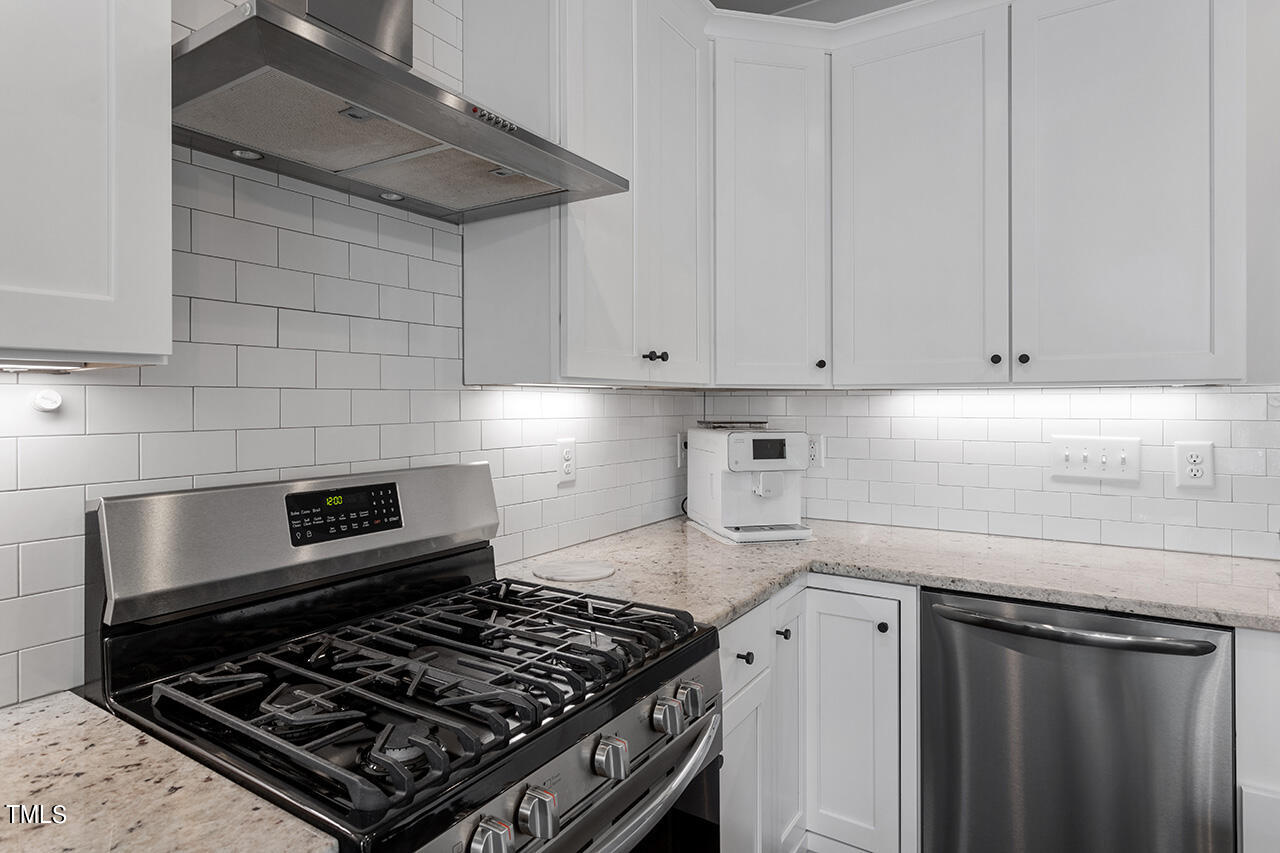 638 Watauga Street Raleigh, NC 27604 - Photo 8 of 41 a kitchen with a stove and white cabinets