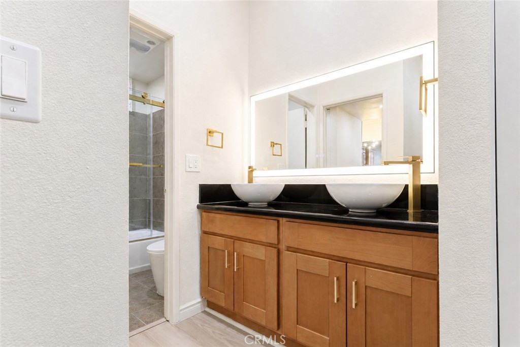 10470 Riverside Drive, Unit 102 Toluca Lake, CA 91602 - Photo 16 of 35 a bathroom with a sink and a mirror