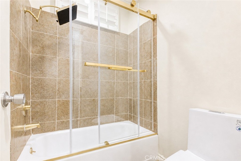 10470 Riverside Drive, Unit 102 Toluca Lake, CA 91602 - Photo 17 of 35 a bathroom with a bathtub and shower