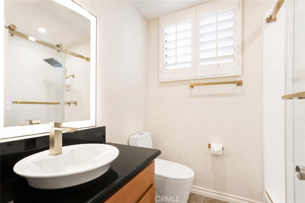 10470 Riverside Drive, Unit 102 Toluca Lake, CA 91602 - Photo 21 of 35 a bathroom with a sink and a mirror