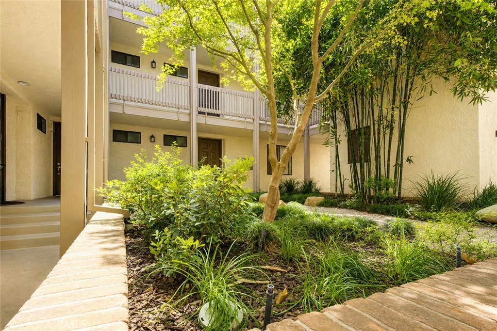 10470 Riverside Drive, Unit 102 Toluca Lake, CA 91602 - Photo 25 of 35 a view of a pathway with a garden