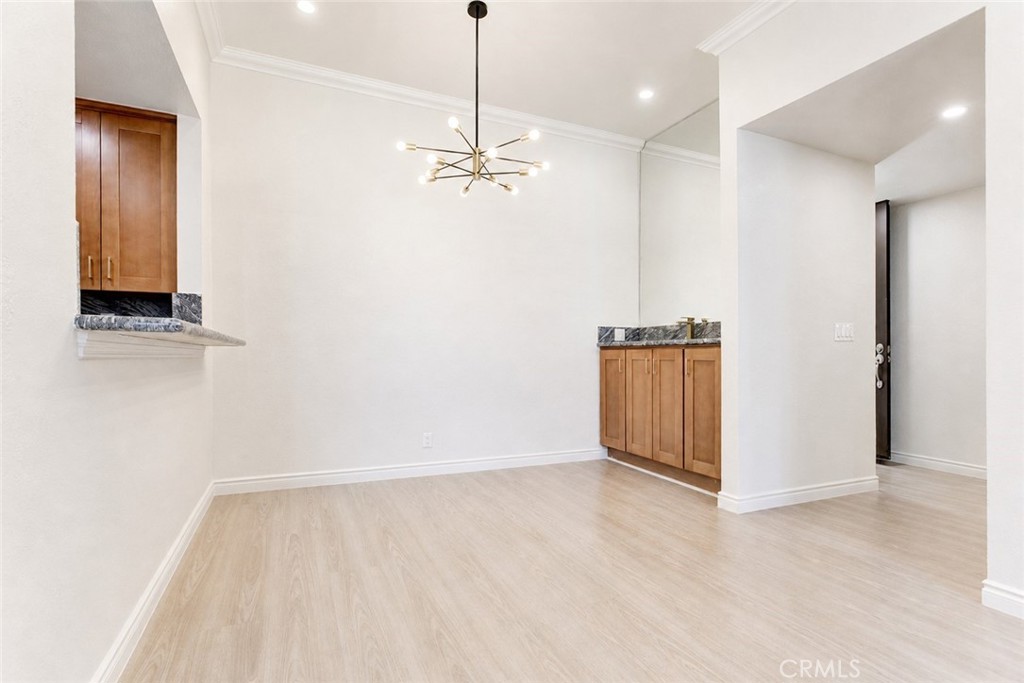 10470 Riverside Drive, Unit 102 Toluca Lake, CA 91602 - Photo 7 of 35 a view of empty room with wooden floor