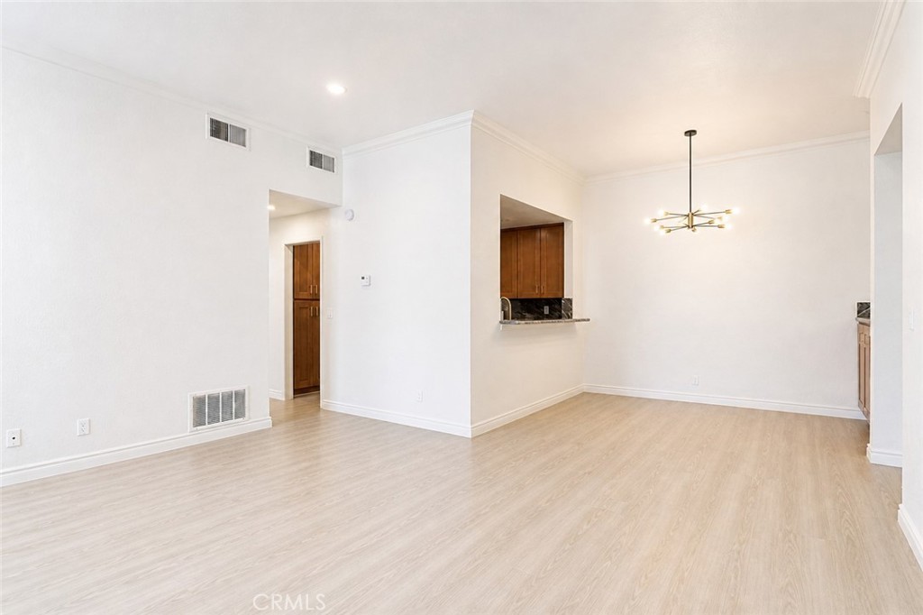 10470 Riverside Drive, Unit 102 Toluca Lake, CA 91602 - Photo 8 of 35 a view of empty room with wooden floor and fireplace