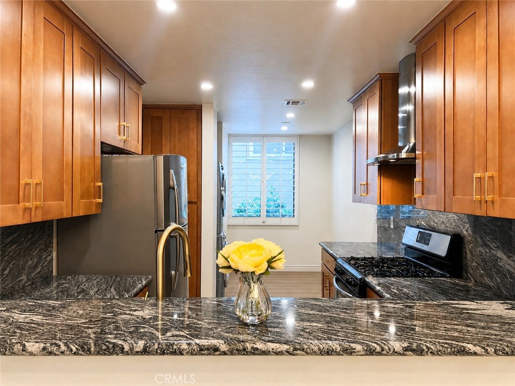 10470 Riverside Drive, Unit 102 Toluca Lake, CA 91602 - Photo 9 of 35 a kitchen with stainless steel appliances granite countertop a refrigerator and a sink