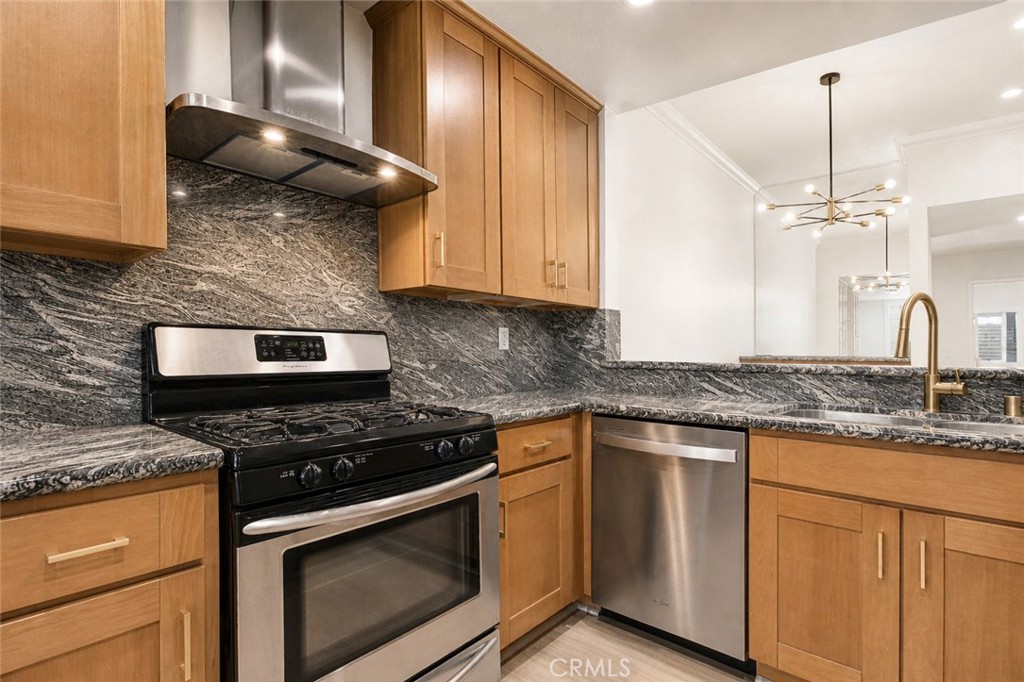 10470 Riverside Drive, Unit 102 Toluca Lake, CA 91602 - Photo 10 of 35 a kitchen with stainless steel appliances granite countertop a stove a sink and a microwave