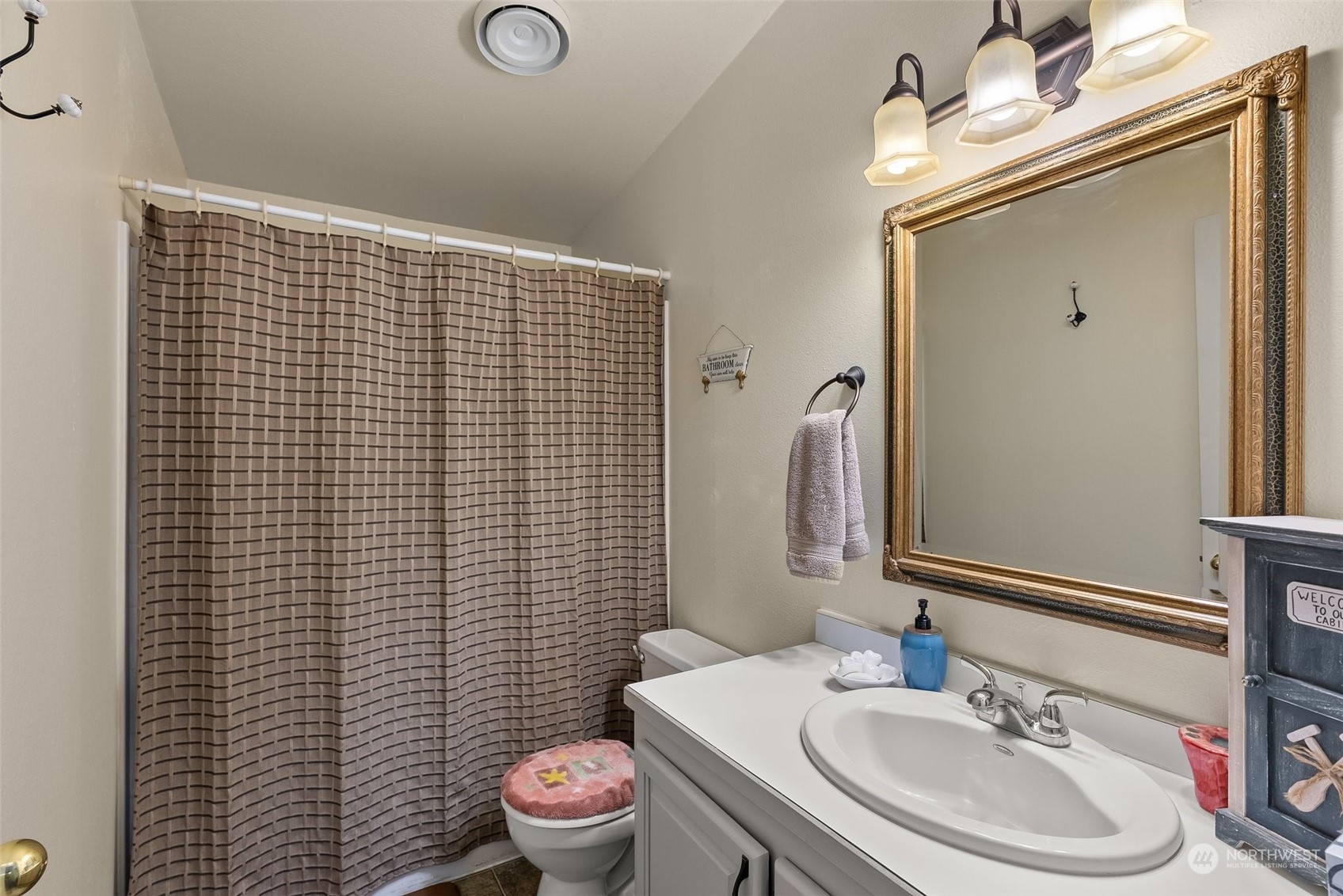 14940 Military Road Southeast Tenino, WA 98589 - Photo 18 of 30 a bathroom with a sink a toilet and mirror