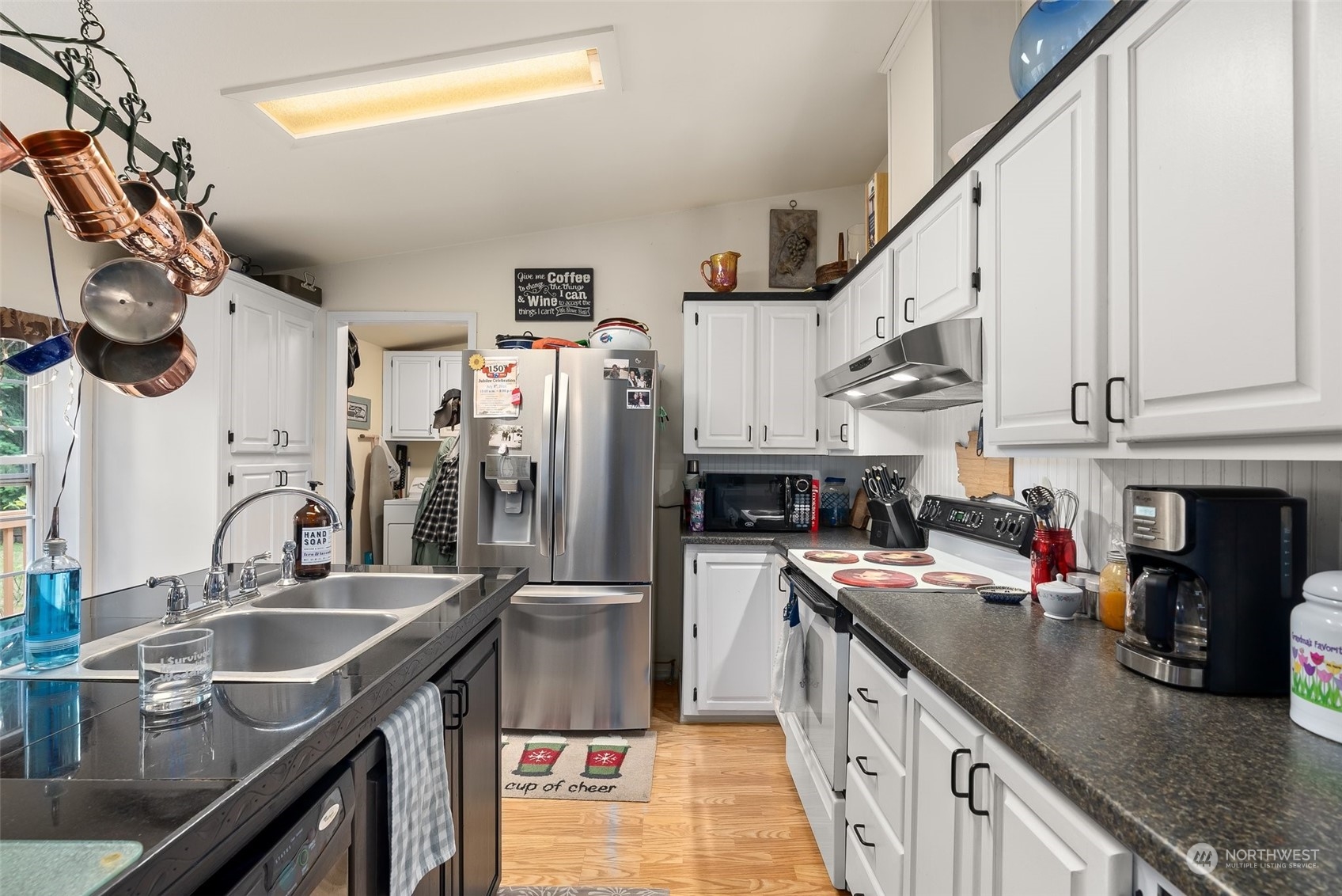 14940 Military Road Southeast Tenino, WA 98589 - Photo 8 of 30 a kitchen with stainless steel appliances granite countertop a sink a stove and a refrigerator