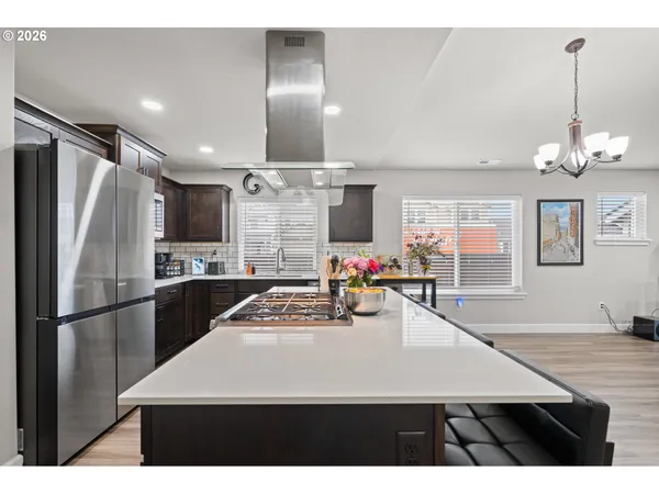 a kitchen with stainless steel appliances a refrigerator sink and stove