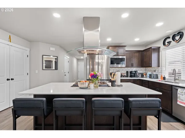 a kitchen with a sink cabinets and wooden floor