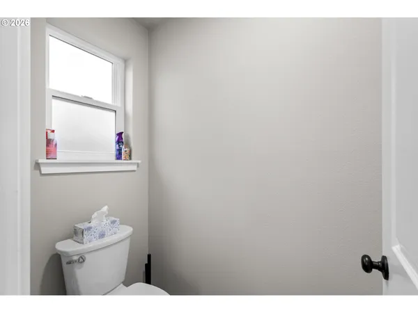 a bathroom with a sink mirror vanity and toilet