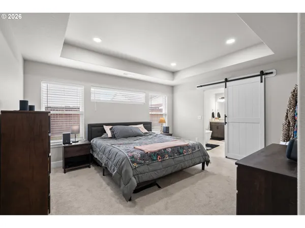 a bedroom with a bed window and a wall painting