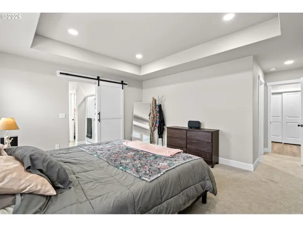 a bedroom with a bed and a dresser