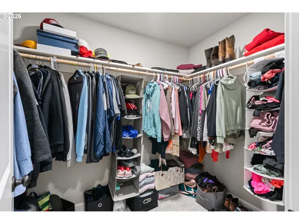 a view of walk in closet with clothes