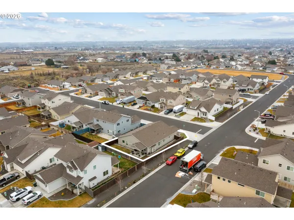 an aerial view of residential houses with city view