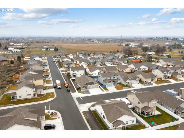 an aerial view of residential building with parking