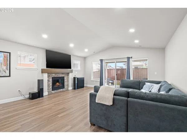 a living room with furniture a fireplace and a flat screen tv