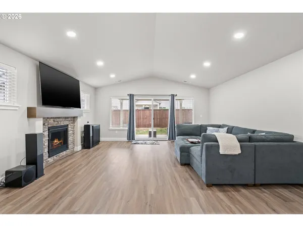 a living room with fireplace furniture and a flat screen tv