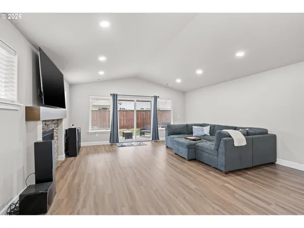 a living room with fireplace furniture and a flat screen tv