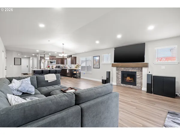 a living room with furniture a fireplace and a flat screen tv