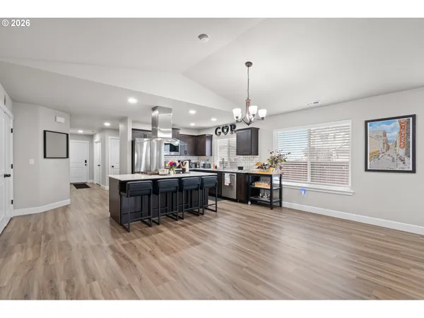 a living room with furniture and kitchen view