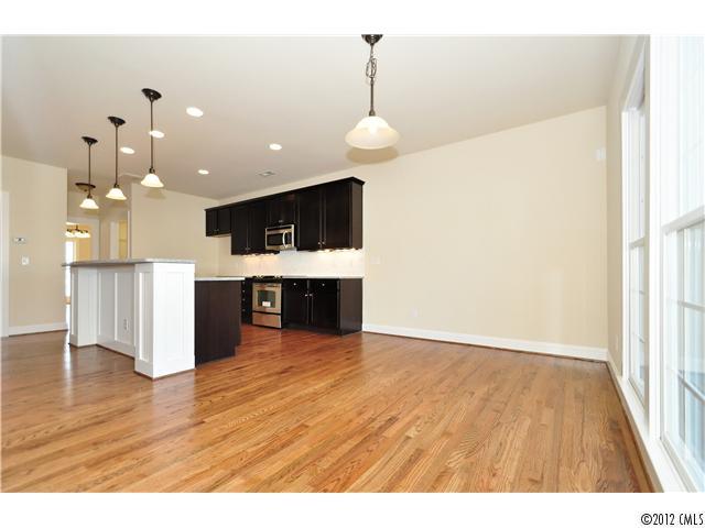 3426 Richard's Crossing Fort Mill, SC 29708 - Photo 12 of 16 a view of a kitchen with wooden floor and a ceiling fan