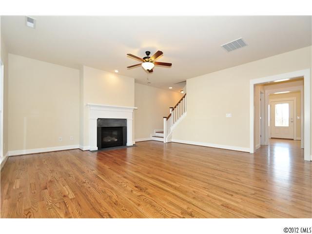 3426 Richard's Crossing Fort Mill, SC 29708 - Photo 7 of 16 a view of an empty room with chandelier fan and wooden floor