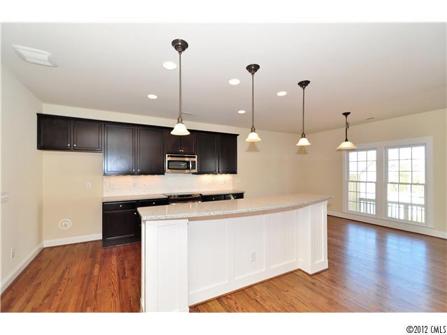 3426 Richard's Crossing Fort Mill, SC 29708 - Photo 9 of 16 a open kitchen with kitchen island a sink stainless steel appliances and cabinets