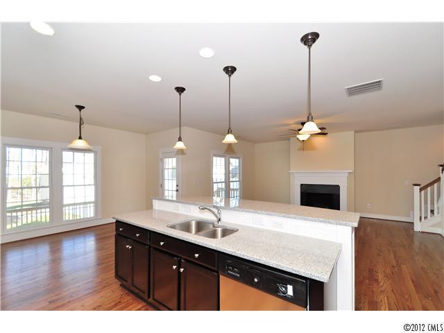 3426 Richard's Crossing Fort Mill, SC 29708 - Photo 10 of 16 a kitchen with a sink chandelier and living room view