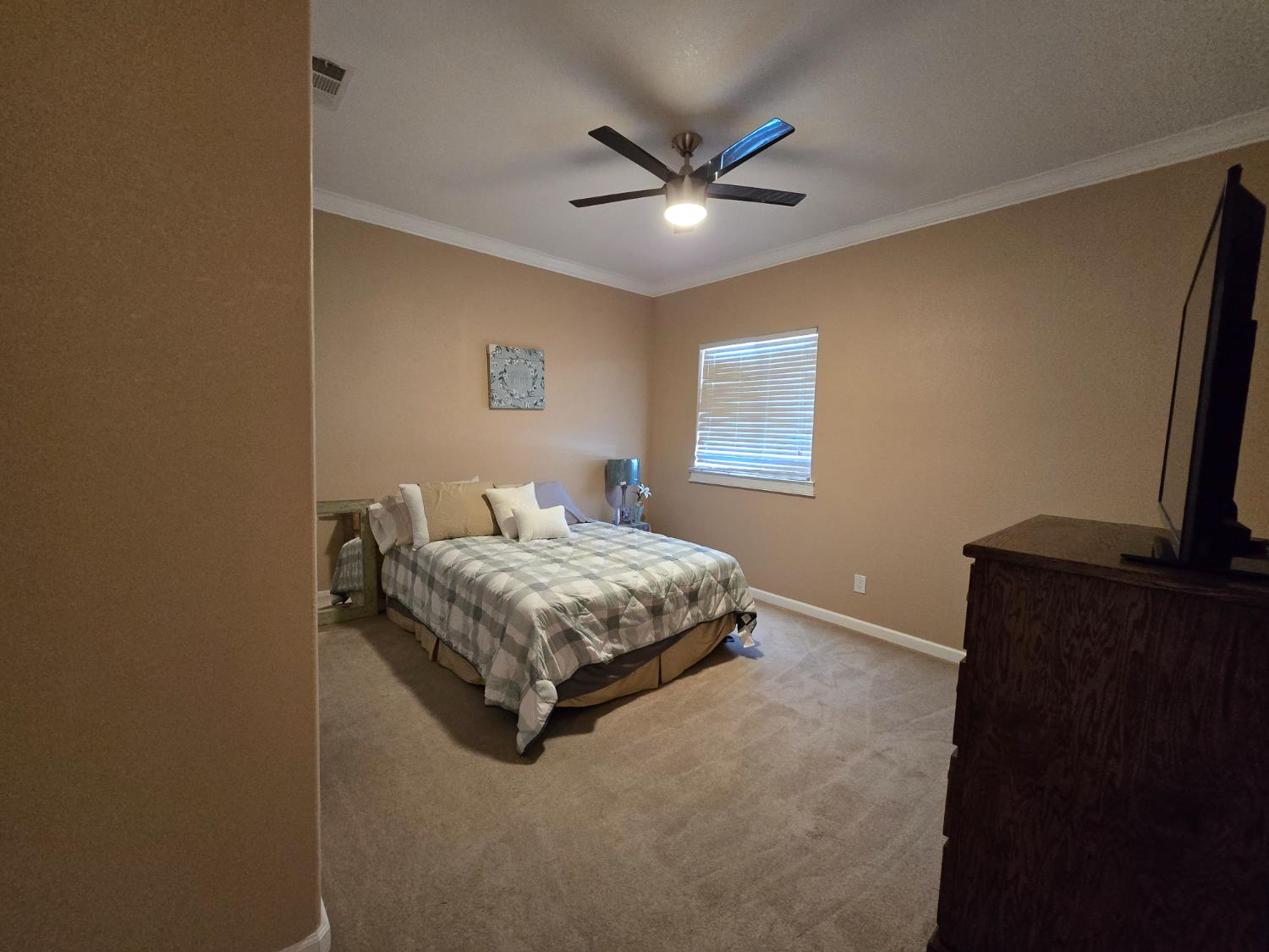5995 West Brooks Road Merced, CA 95341 - Photo 14 of 23 a bedroom with a bed and a flat screen tv
