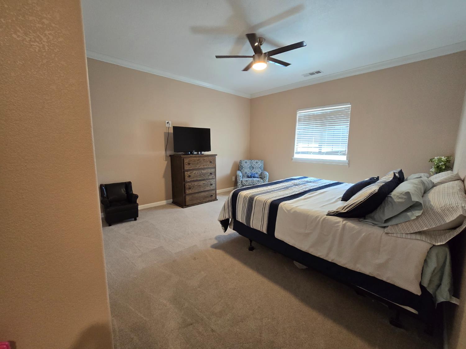 5995 West Brooks Road Merced, CA 95341 - Photo 15 of 23 a bedroom with a bed and a flat screen tv