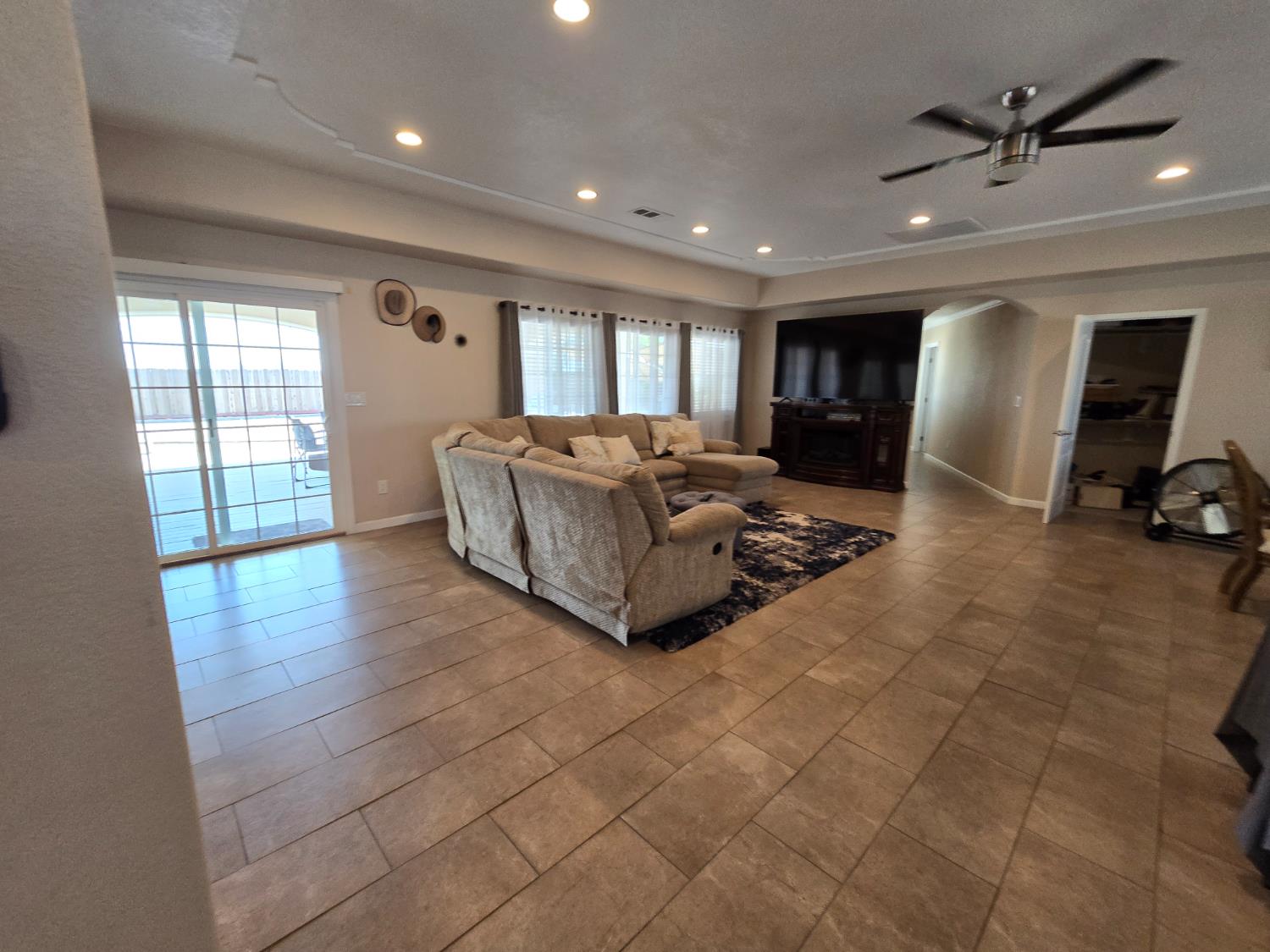 5995 West Brooks Road Merced, CA 95341 - Photo 9 of 23 a living room with couches and a flat screen tv