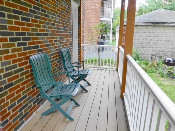 a view of balcony with wooden floor and outdoor seating