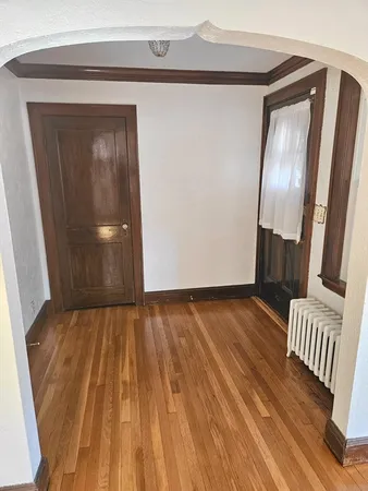 a view of front door with wooden floor