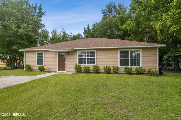 a front view of house with yard and green space